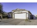 One-story house with a white two-car garage and nicely landscaped yard at 1374 E Kingman Pl, Casa Grande, AZ 85122