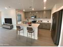 Modern kitchen with gray cabinets and an island at 1393 W Inca Dr, Coolidge, AZ 85128