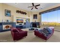 Spacious living room with fireplace, large windows, and mountain views at 15418 N Castillo Dr, Fountain Hills, AZ 85268