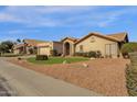 House exterior showcasing a two-car garage and well-maintained landscaping at 160 W La Vieve Ln, Tempe, AZ 85284