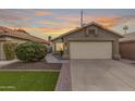 Tan house with a two-car garage and landscaped front yard at 16019 S 40Th Way, Phoenix, AZ 85048