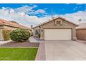 Tan house exterior with a two-car garage and landscaping at 16019 S 40Th Way, Phoenix, AZ 85048