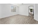 Bright dining room with wood-look tile floor and access to other rooms at 16508 N 71St Ave, Peoria, AZ 85382