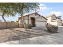 Charming one-story home with front yard landscaping and trees at 16508 N 71St Ave, Peoria, AZ 85382