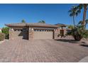 View of a three-car garage and paved driveway at 19941 N Summer Dream Dr, Surprise, AZ 85374