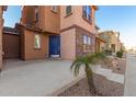 Townhome with a blue front door and small patio at 2028 N 77Th Ln, Phoenix, AZ 85035