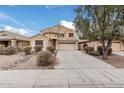 Two-story house with tan exterior, attached garage, and landscaping at 20475 N Herbert Ave, Maricopa, AZ 85138