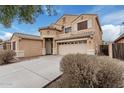 Two-story house with tan exterior, attached garage, and landscaping at 20475 N Herbert Ave, Maricopa, AZ 85138