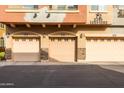 Attached two-car garage with tan doors and stone accents at 2150 W Alameda Rd # 1251, Phoenix, AZ 85085