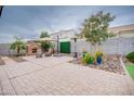 Landscaped backyard with patio, fire pit, and seating area at 21556 S 215Th Pl, Queen Creek, AZ 85142