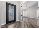 Elegant entryway with a black door and wood floors at 25037 S Ribbonwood Dr, Sun Lakes, AZ 85248