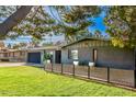 Mid-century modern home with gray brick facade and a modern fence at 2942 N 81St Pl, Scottsdale, AZ 85251