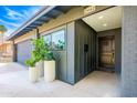 Attractive front entrance featuring a well-lit doorway, complemented by potted plants and a clean, modern aesthetic at 2942 N 81St Pl, Scottsdale, AZ 85251