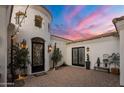 Charming courtyard entry with a wrought-iron door and string lights at 3038 E Waterman Way, Gilbert, AZ 85297