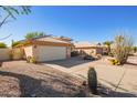 View of the home's exterior, including the garage and driveway at 3531 E Utopia Rd, Phoenix, AZ 85050