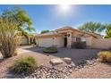 Front yard view of charming one-story house with rock landscaping at 3531 E Utopia Rd, Phoenix, AZ 85050