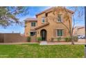 Tan two-story house with landscaping and walkway at 3667 E Angstead Ct, Gilbert, AZ 85296