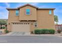 Tan two-car garage with landscaping at 3667 E Angstead Ct, Gilbert, AZ 85296