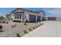 Two-car garage and side yard view of a new construction home at 39012 N 6Th Dr, Phoenix, AZ 85086