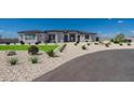 Modern house exterior with a landscaped front yard and driveway at 39027 N 6Th Dr, Phoenix, AZ 85086