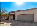 Single-story home with a gray garage door and landscaped front yard at 3921 W Sharon Ave, Phoenix, AZ 85029