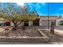 Single-story home with a gray garage door and landscaped front yard at 3921 W Sharon Ave, Phoenix, AZ 85029