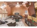 Spacious living room featuring a sectional sofa and a fireplace at 3921 W Sharon Ave, Phoenix, AZ 85029