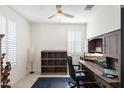 Home office with wood desk, chair, and shelving at 41703 W Mesquite Rd, Maricopa, AZ 85138