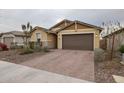 Modern house with a brown garage door and neatly landscaped yard at 4524 S 127Th Ln, Avondale, AZ 85323