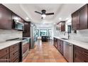 Modern kitchen with dark cabinetry, stainless steel appliances, and terracotta tile floors at 4979 E Calle De Los Arboles --, Cave Creek, AZ 85331