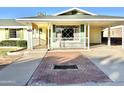 Ranch-style home with covered porch and brick walkway at 5708 W Belmont Ave, Glendale, AZ 85301