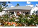 White roses climbing a fence, partially obscuring view of house at 6602 E Lafayette Blvd, Scottsdale, AZ 85251