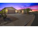 Attractive two-story home with a three-car garage and palm trees in the front at 6616 S Bridal Vail Dr, Gilbert, AZ 85298