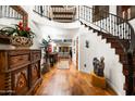 Elegant hallway with hardwood floors and curved staircase at 7500 E Mccormick Pkwy # 63, Scottsdale, AZ 85258