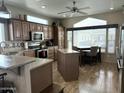 Open concept kitchen with large island, stainless steel appliances, and corner sink at 7750 E Broadway Rd # 175, Mesa, AZ 85208