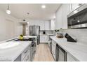 Modern kitchen with white cabinets, stainless steel appliances, and large island at 7756 E San Miguel Ave, Scottsdale, AZ 85250