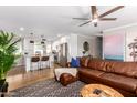 Open concept living room with kitchen views and leather sectional sofa at 920 E 10Th Pl, Mesa, AZ 85203