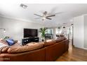 Spacious living room with a brown leather sectional sofa and hardwood floors at 920 E 10Th Pl, Mesa, AZ 85203