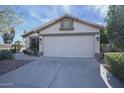 Front view of a single story home with a two car garage at 11517 W Coral Snake Ct, Surprise, AZ 85378