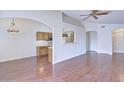 Open living area with hardwood floors and kitchen pass-through at 11517 W Coral Snake Ct, Surprise, AZ 85378