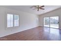 Bright living room featuring hardwood floors and sliding glass doors at 11517 W Coral Snake Ct, Surprise, AZ 85378
