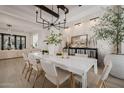 Open concept dining room with white table and stone accent wall at 20177 E Via De Arboles --, Queen Creek, AZ 85142