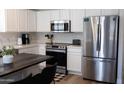 Modern kitchen with stainless steel appliances and white cabinets at 26411 N 41St St, Phoenix, AZ 85050