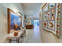 View into living room from hallway, featuring artwork and a console table at 35167 N 92Nd Pl, Scottsdale, AZ 85262