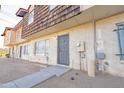 Side view of a tan and brown townhome with a gray door and desert landscaping at 3605 W Bethany Home Rd # 10, Phoenix, AZ 85019
