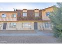Front view of a tan and brown townhome with desert landscaping at 3605 W Bethany Home Rd # 10, Phoenix, AZ 85019