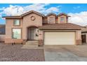 Two-story house with a beige exterior, two-car garage, and landscaping at 524 N Leoma Ln, Chandler, AZ 85225