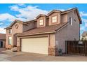 Two-story house with beige exterior, two-car garage, and a gated driveway at 524 N Leoma Ln, Chandler, AZ 85225