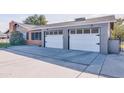 Two-car garage with white doors and concrete driveway at 6850 N 15Th Pl, Phoenix, AZ 85014