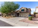 Two-story house with a landscaped yard and a two-car garage at 7720 S 72Nd Ave, Laveen, AZ 85339